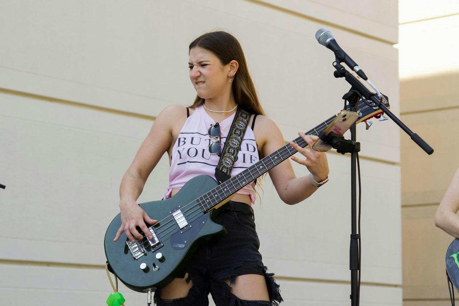 FILE - Lead singer of the band Bad Blood Hope Overlook plays the guitar during a performance at Plazapolooza on Oct. 2, 2023. Overlook started the band in September 2023.