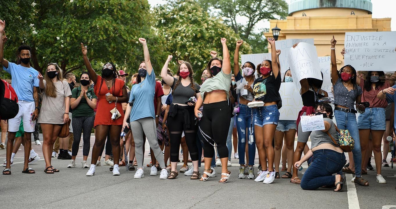 Students cheer after two white students yelled, “Black lives matter,” out their car window after being told they can’t park outside the gates on Bull Street.&nbsp;