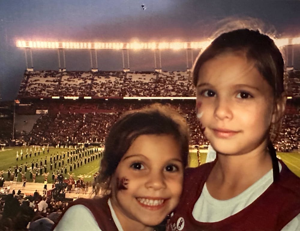 <p>Camila Burnett (left) and Sophia Burnett (right) at Williams-Brice Stadium as young kids. More than a decade later, they would be reunited at the University of South Carolina as students and golf teammates.</p>