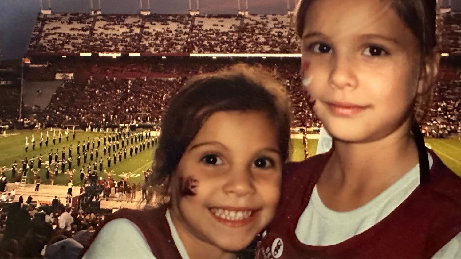 Camila Burnett (left) and Sophia Burnett (right) at Williams-Brice Stadium as young kids. More than a decade later, they would be reunited at the University of South Carolina as students and golf teammates.