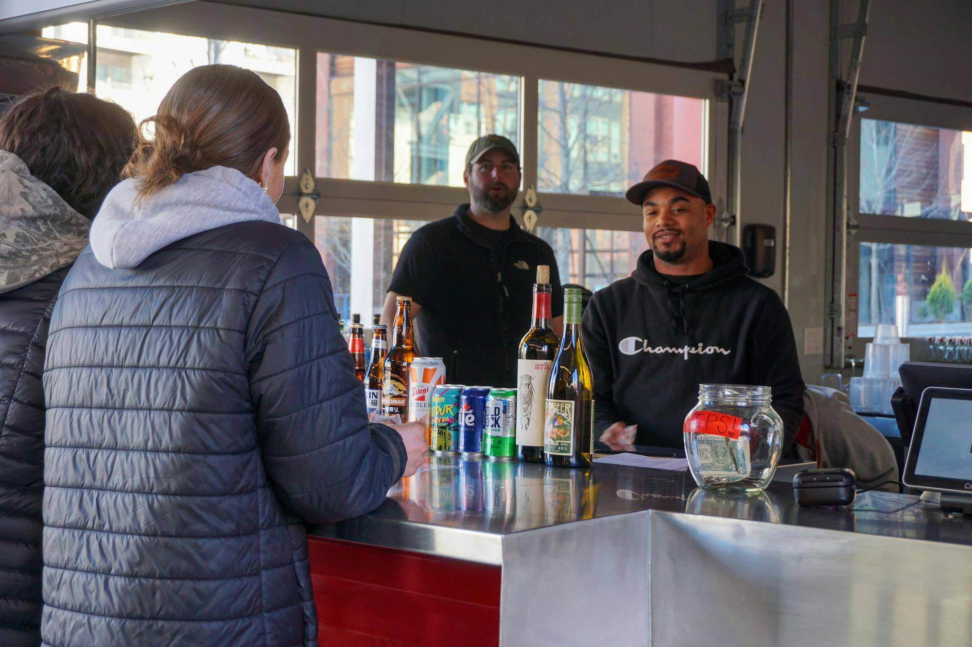 Session Taproom employees take a break in Gather COLA on Jan. 20, 2026, in the BullStreet District. Gather COLA offers multiple food options and space to eat and gather with friends and family.