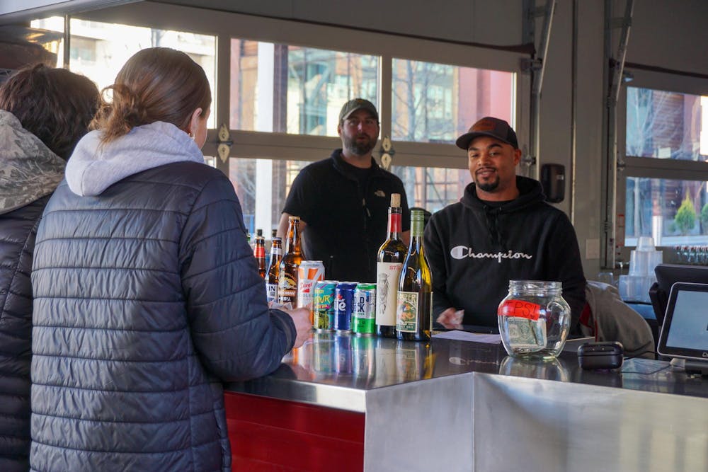 <p>Session Taproom employees take a break in Gather COLA on Jan. 20, 2026, in the BullStreet District. Gather COLA offers multiple food options and space to eat and gather with friends and family.</p>