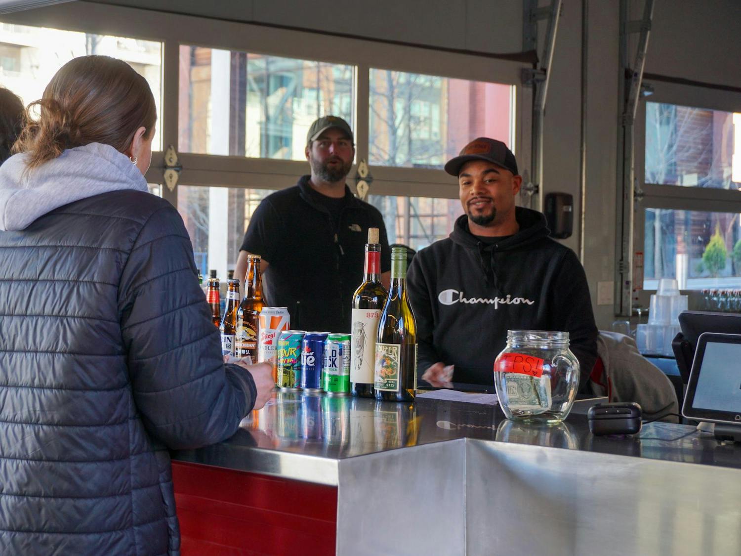 Session Taproom employees take a break in Gather COLA on Jan. 20, 2026, in the BullStreet District. Gather COLA offers multiple food options and space to eat and gather with friends and family.