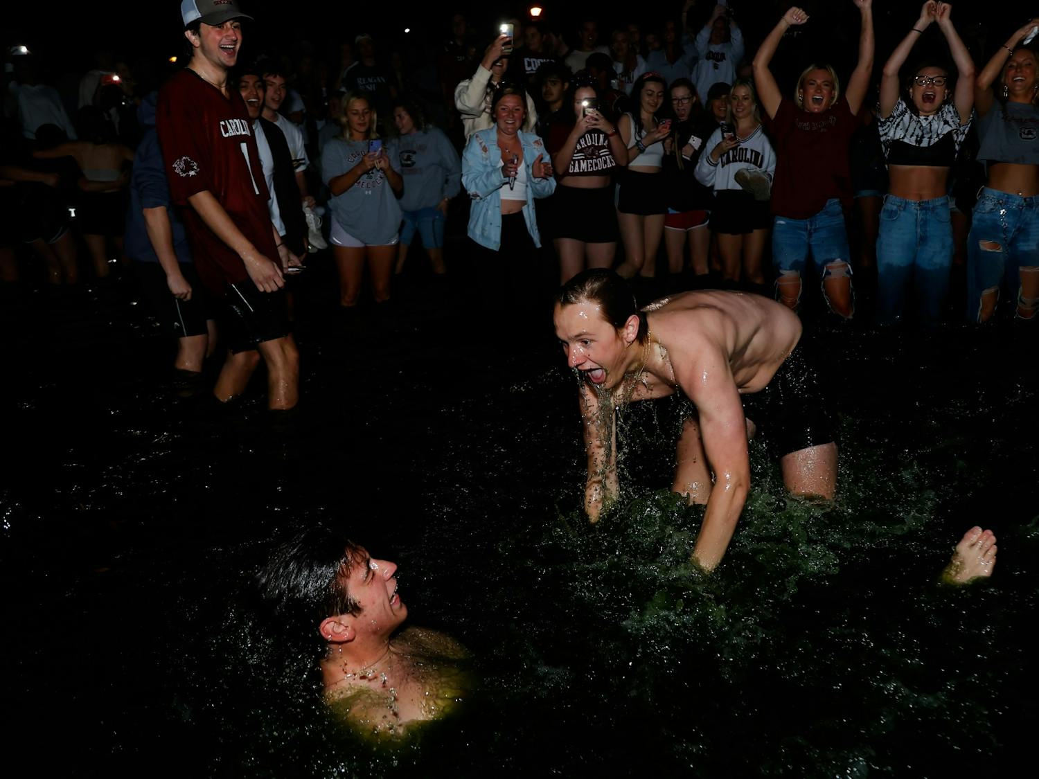 South Carolina students wrestle in the Thomas Cooper Library fountain after hundreds of students jumped in the water to celebrate the women's basketball team’s win over the University of Connecticut in the national championship.  