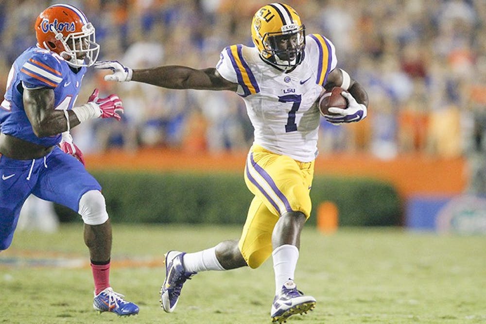 Louisiana State running back Leonard Fournette (7) evades Florida defensive back Keanu Neal (42) at bay during the second quarter at Ben Hill Griffin Stadium in Gainesville, Fla., on Saturday, Oct. 11, 2014. (Eve Edelheit/Tampa Bay Times/MCT)