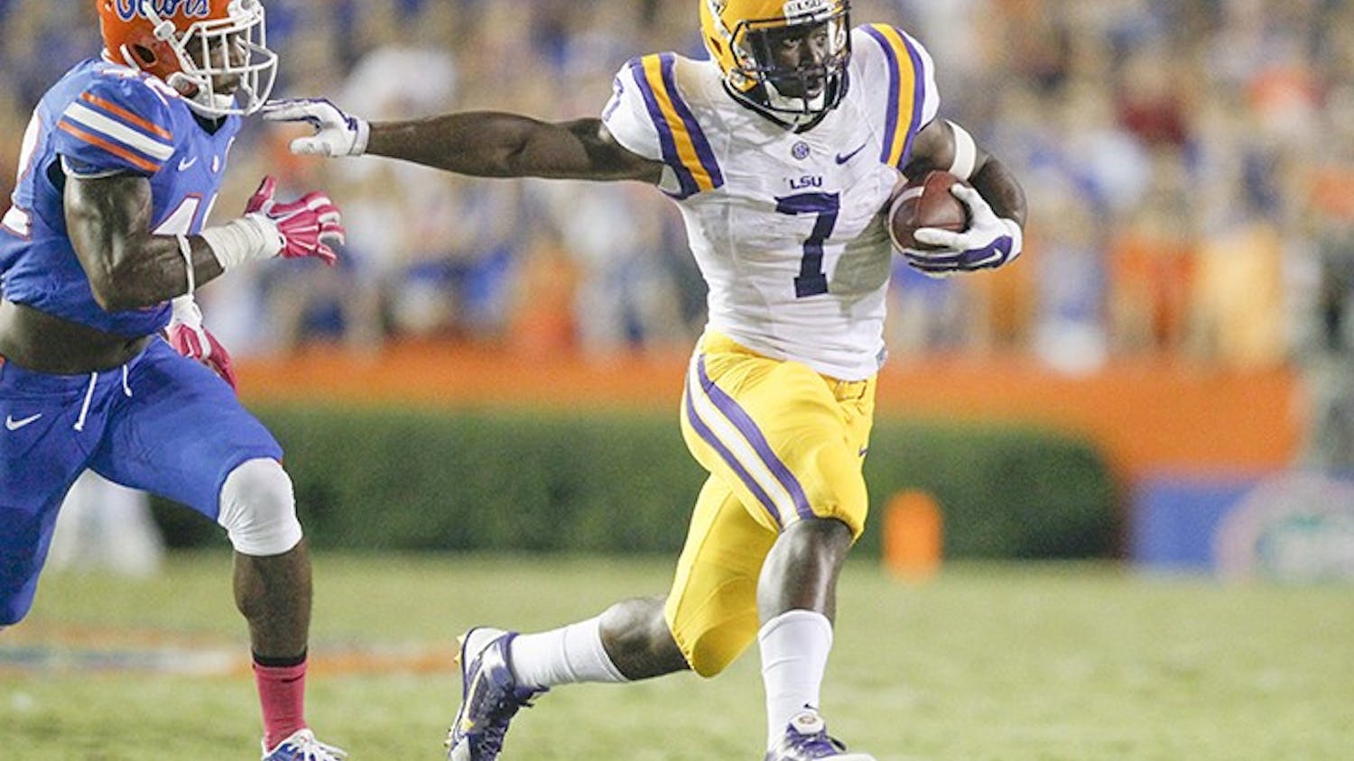 Louisiana State running back Leonard Fournette (7) evades Florida defensive back Keanu Neal (42) at bay during the second quarter at Ben Hill Griffin Stadium in Gainesville, Fla., on Saturday, Oct. 11, 2014. (Eve Edelheit/Tampa Bay Times/MCT)