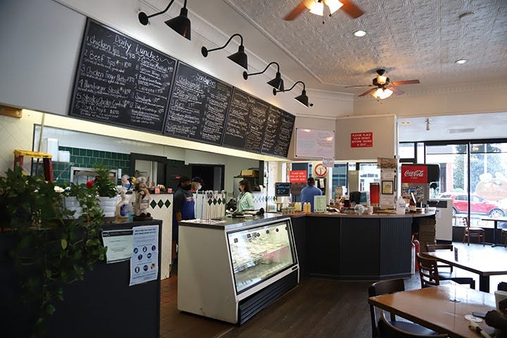 The inside counter, right below a row of menus where customers will place their orders. The restaurant provides both indoor and outdoor seating.