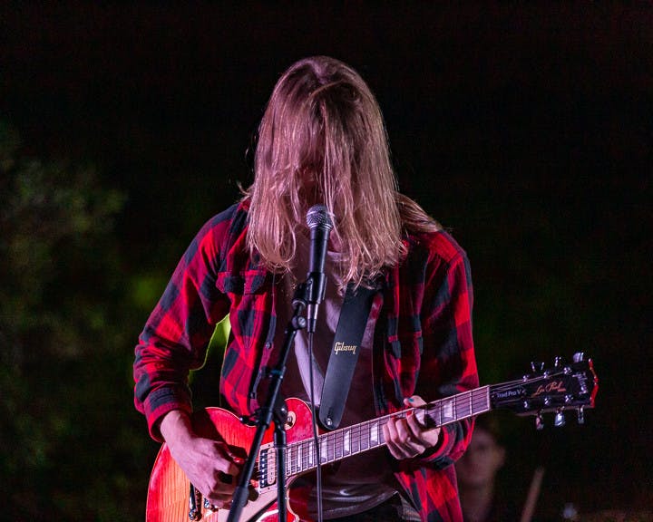 Fourth-year computer science and math student Josh Dietrich, the frontman for Cockpit, plays guitar at the Battle of the Bands on Oct. 5, 2022. &nbsp;The competition brought acappella, folk, rap and rock to the Russel House Patio in a variety of performances.&nbsp;