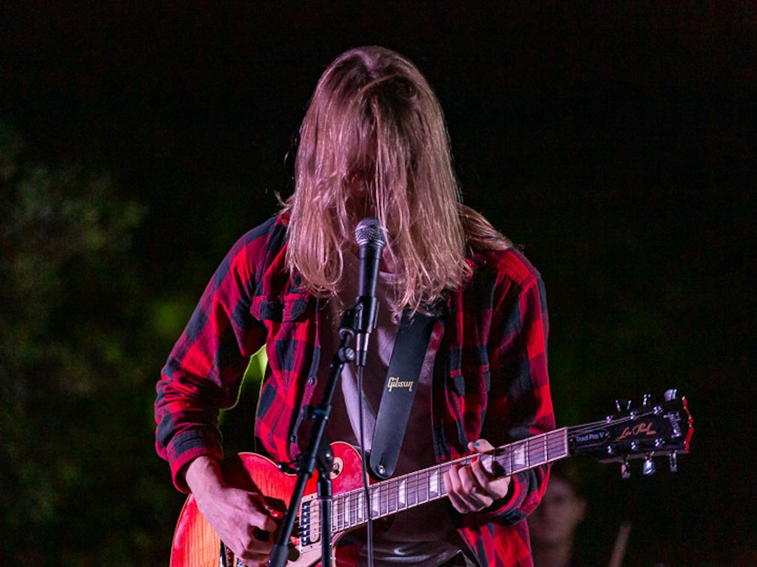 Fourth-year computer science and math student Josh Dietrich, the frontman for Cockpit, plays guitar at the Battle of the Bands on Oct. 5, 2022. &nbsp;The competition brought acappella, folk, rap and rock to the Russel House Patio in a variety of performances.&nbsp;