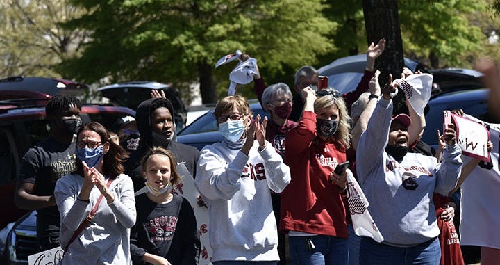 Fans wave, applaud, cheer and wave rally towels to praise and celebrate the return of the USC women’s basketball team.