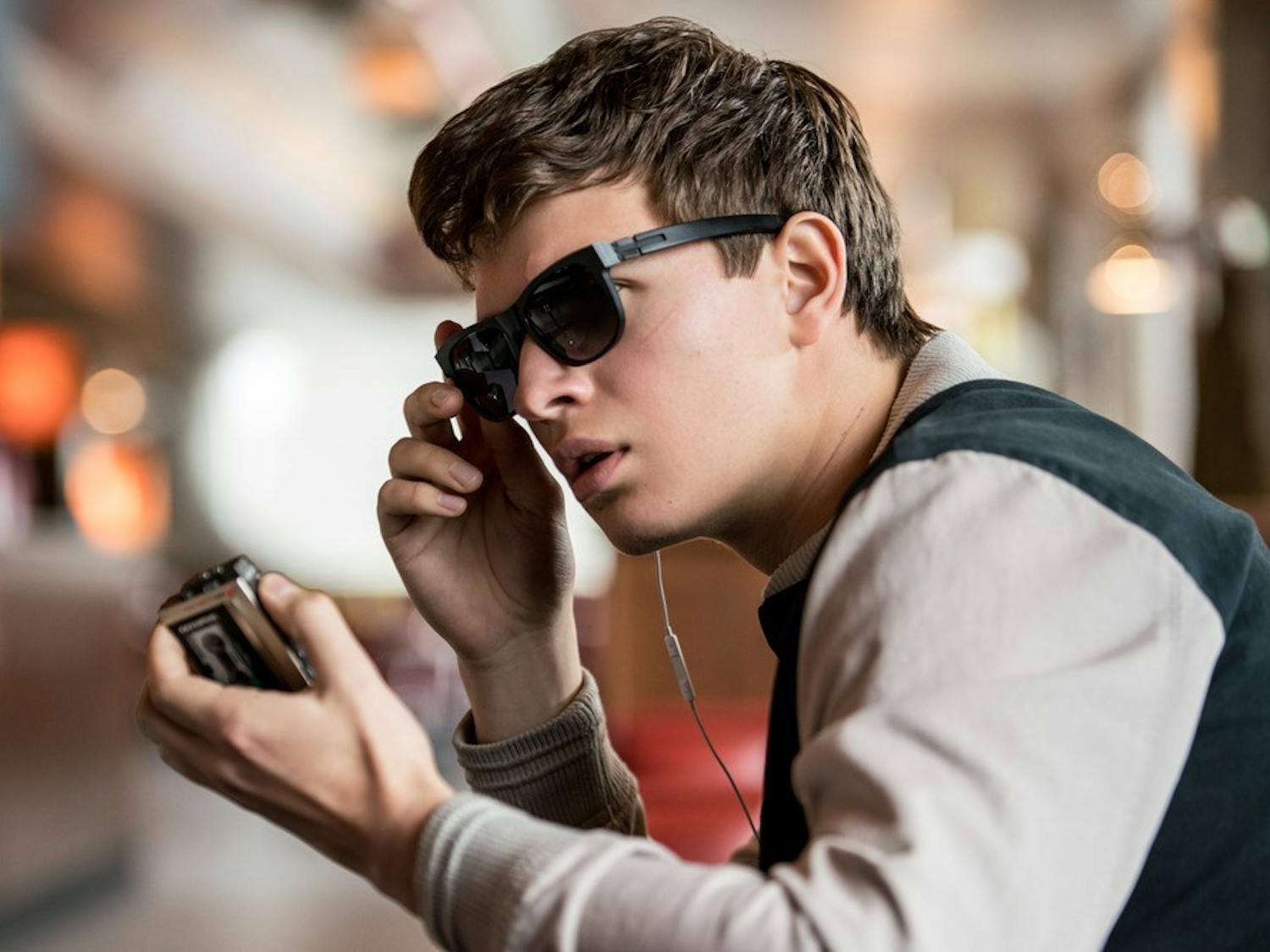 Baby (ANSEL ELGORT) charms Debora as she works in TriStar Pictures' BABY DRIVER.