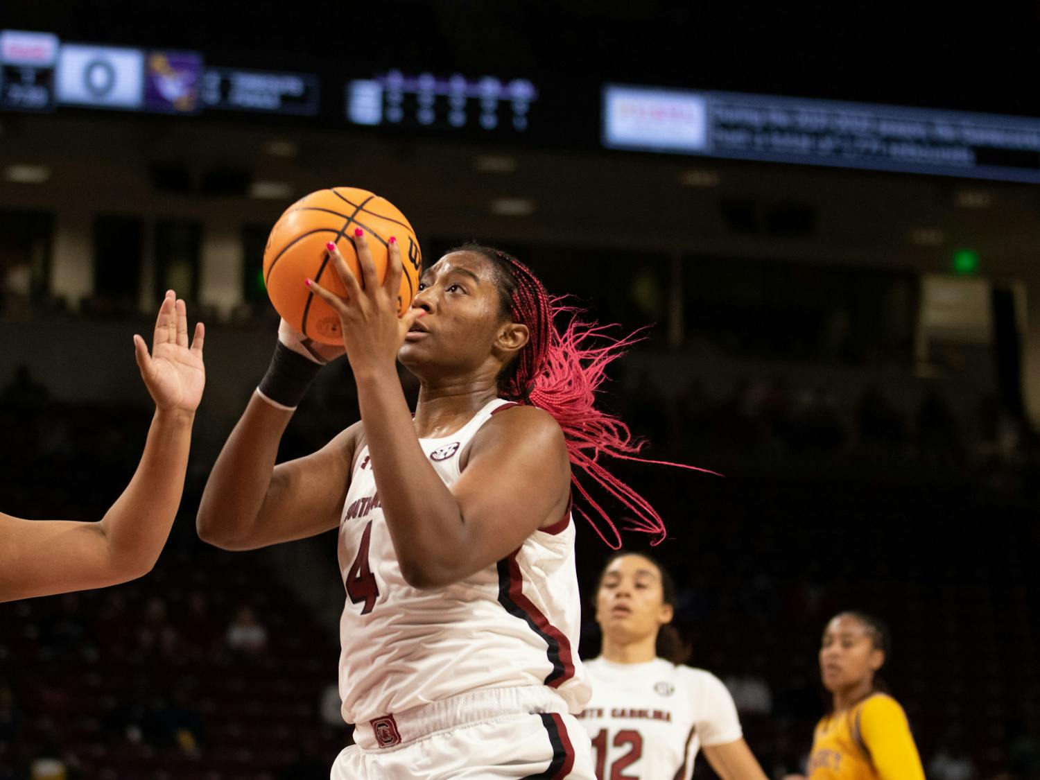 Senior forward Aliyah Boston holds the ball above her head and away from the player from Benedict College during the exhibition game at Colonial Life Arena on Oct. 31, 2022. South Carolina beat the Benedict Tigers in dominant fashion 123-32.