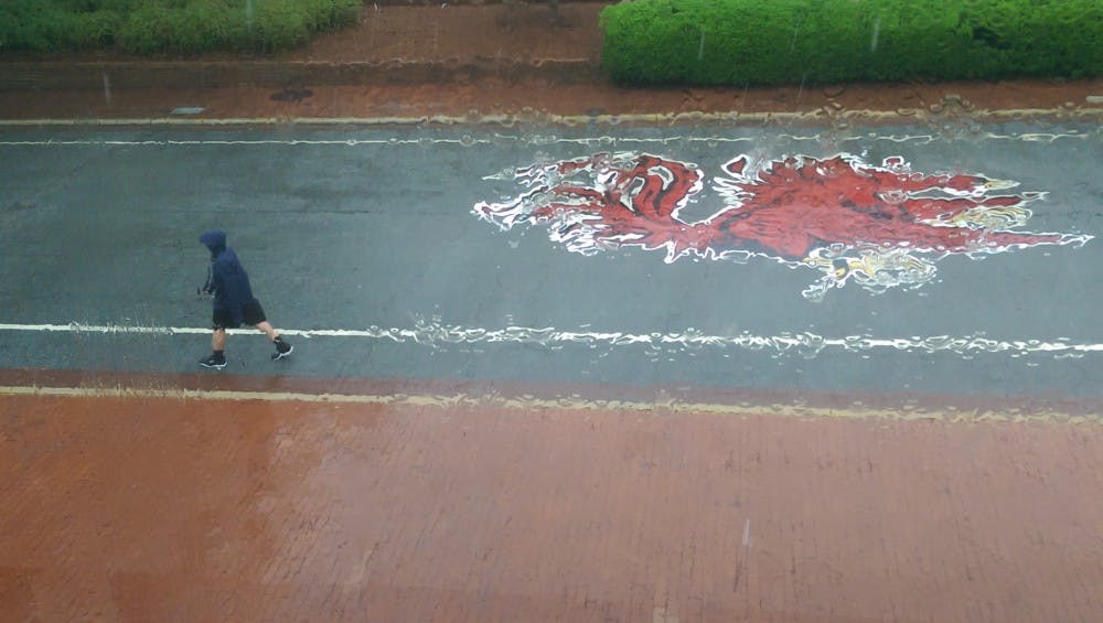 Rain falls on Russell House as students leave campus, their classes cancelled.