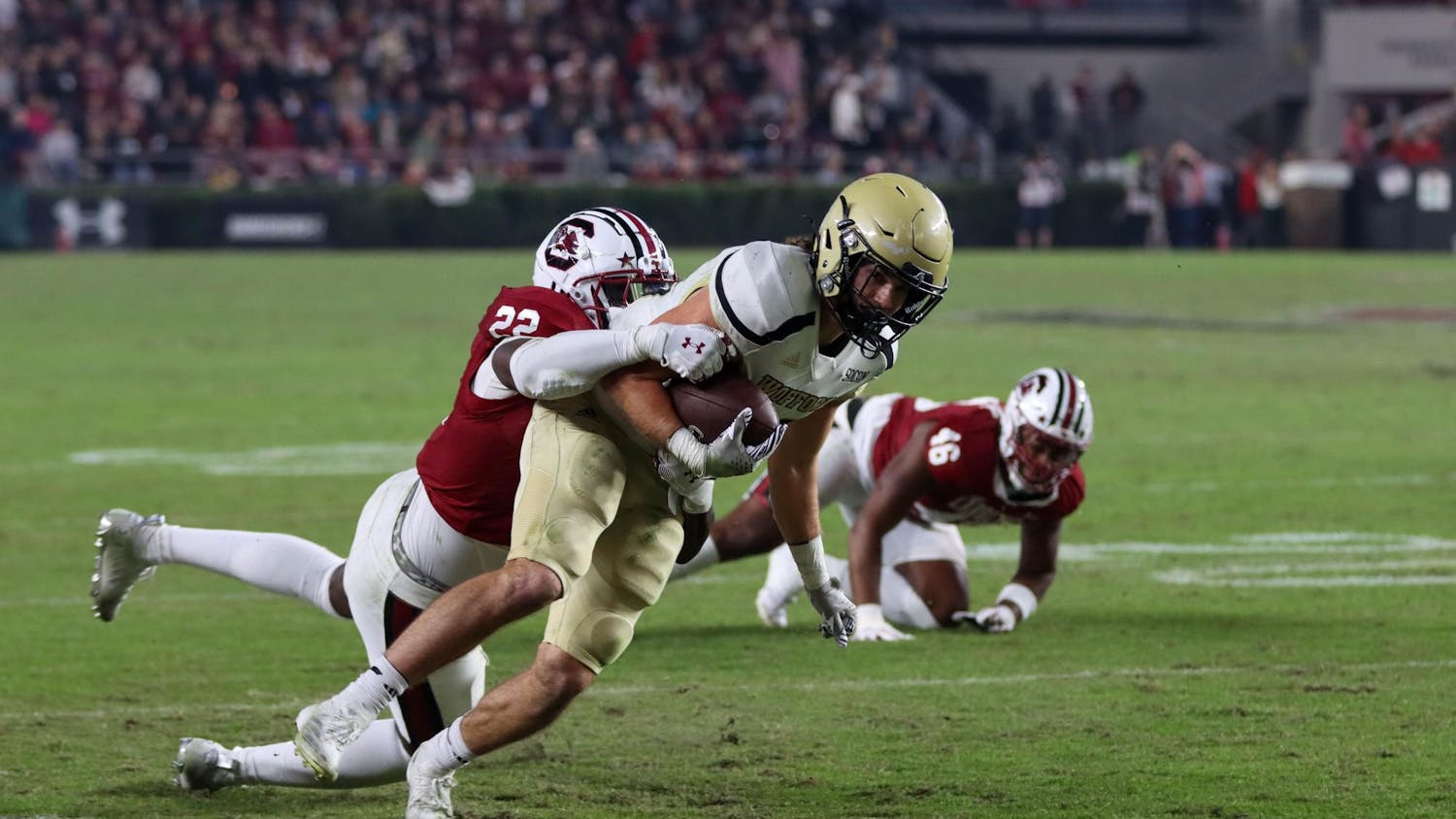 Sixth-year wide receiver Dalevon Campbell and redshirt sophomore defensive back Gerald Kilgore work together to take down an offensive Wofford player. The Gamecocks had four sacks against the Terriers on Nov. 23, 2024.