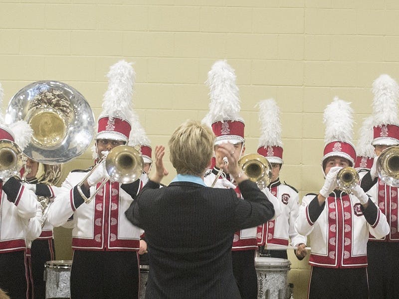 Rebecca Phillips, the associate director of bands, leads the Concocktion Pep Band Tuesday.