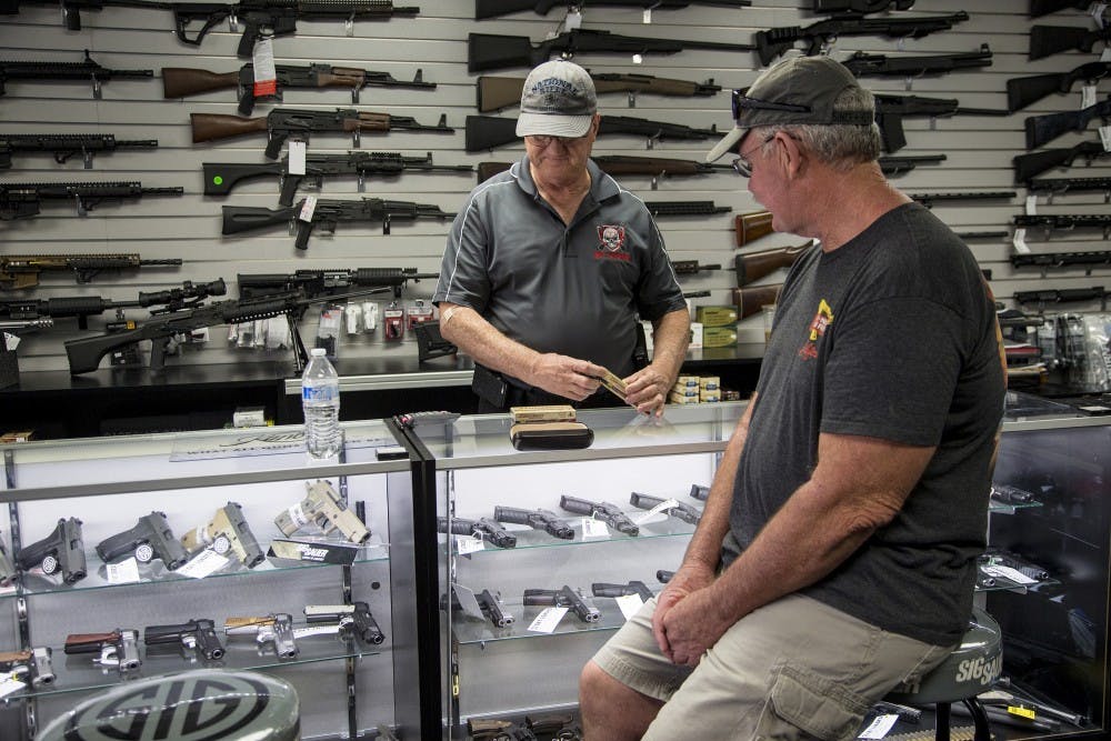 Mike Fiorille, business partner at Get Loaded, serves a customer at the gun store on June 30, 2016, in Grand Terrace, Calif. State lawmakers on Friday, Sept. 1, 2017, gutted a measure that would have limited rifle purchases in the state. (Gina Ferazzi/Los Angeles Times/TNS)