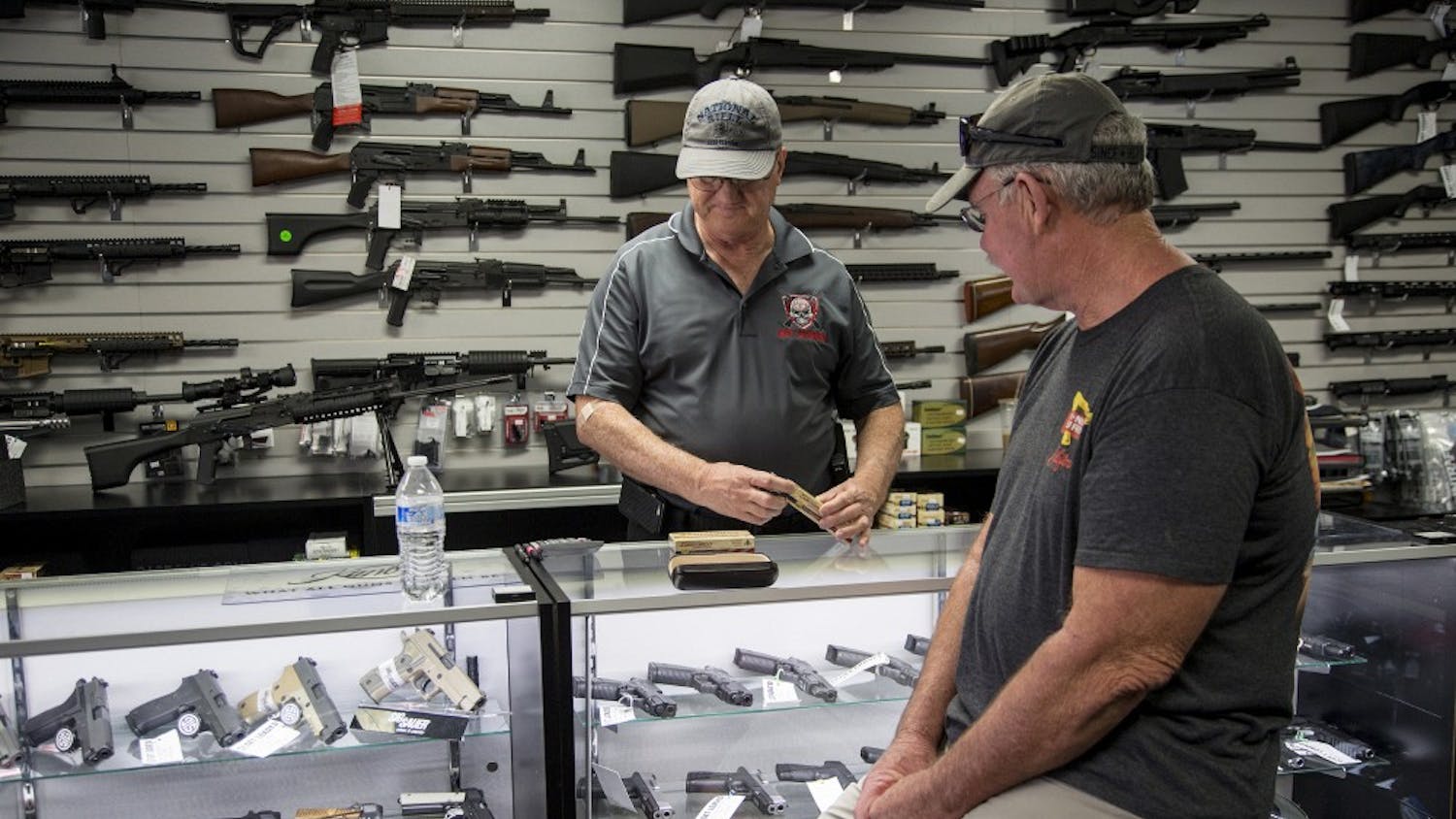 Mike Fiorille, business partner at Get Loaded, serves a customer at the gun store on June 30, 2016, in Grand Terrace, Calif. State lawmakers on Friday, Sept. 1, 2017, gutted a measure that would have limited rifle purchases in the state. (Gina Ferazzi/Los Angeles Times/TNS)