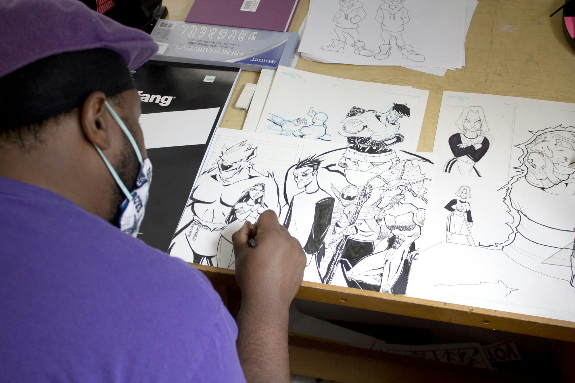 Corey “Roc Bottom” Davis works on several unfinished pieces in his home studio in Columbia, South Carolina. In the future, Davis said, he hopes to open a gallery to promote artists in the Columbia community.