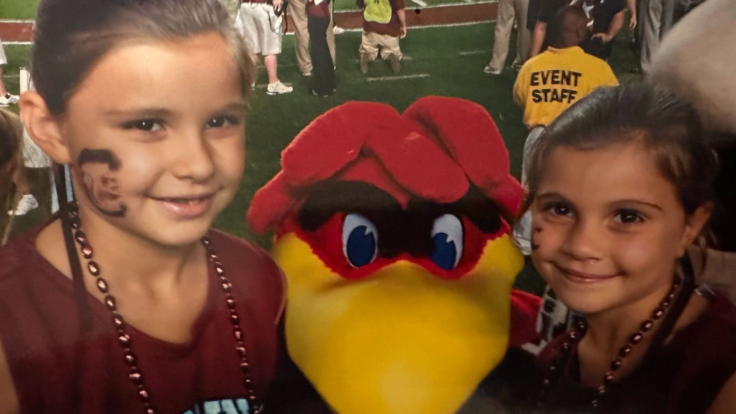 Sophia Burnett (left) and Camila Burnett (right) pose next to Cocky at a football game during their early childhood. The sisters have been playing the game of golf for as long as they can remember.