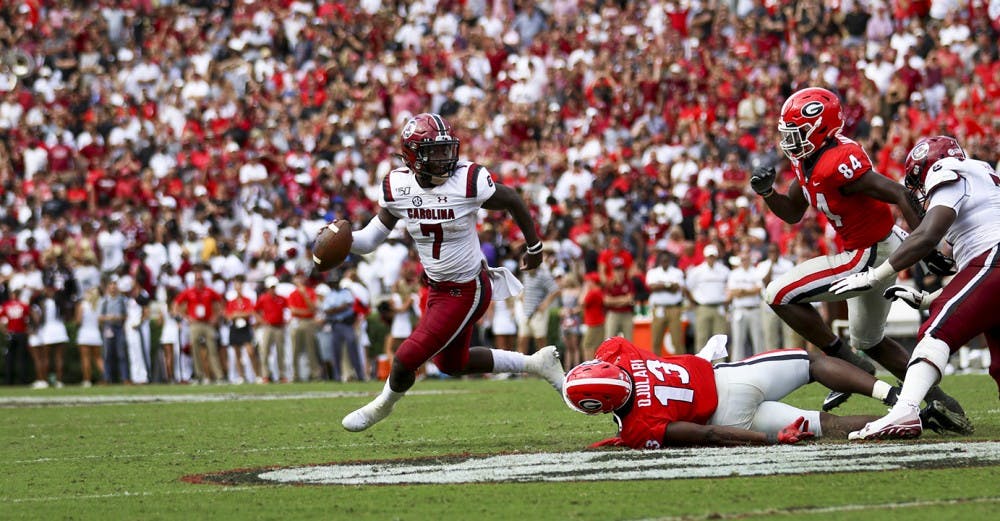 Freshman quarterback Dakereon Joyner runs the ball during the game against UGA.