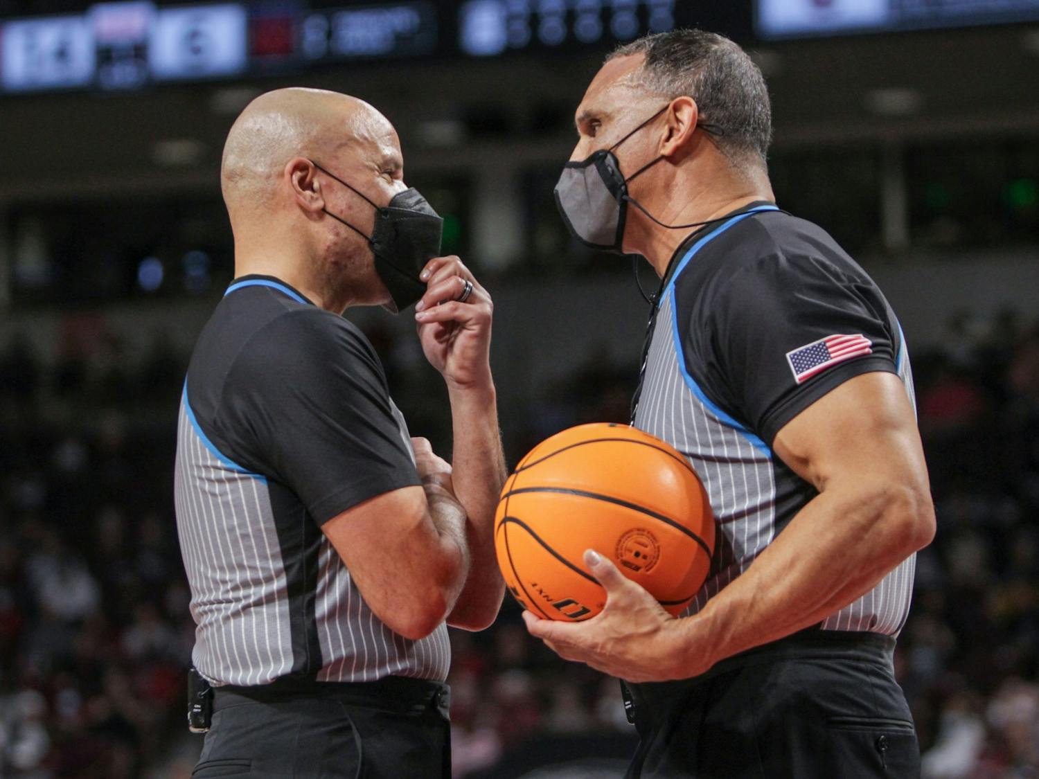 Two officials discuss a call during a game on Feb. 17, 2022 at Colonial Life Arena in Columbia, SC. The Gamecocks beat Auburn 75-38.