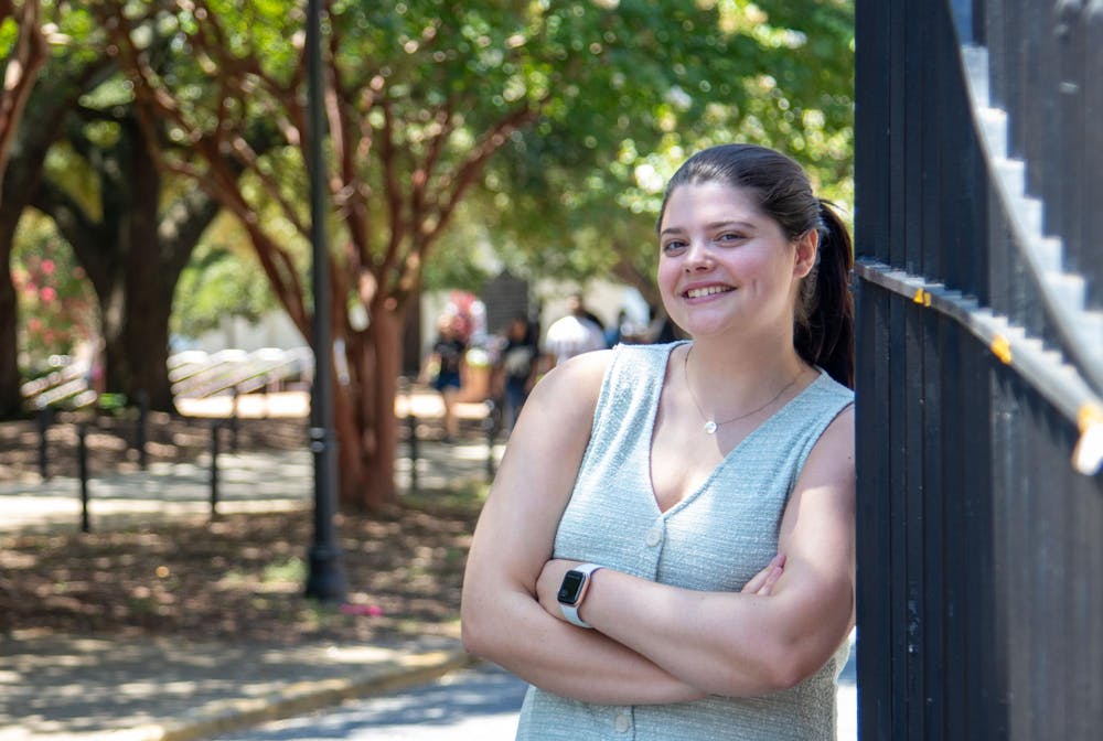 <p>Kate Robins, editor-in-chief of The Daily Gamecock, poses for a photo in front of the gates on Greene Street on Aug. 19, 2024. Robins, a senior at the University of South Carolina, encourages people to take on new experiences and opportunities.</p>