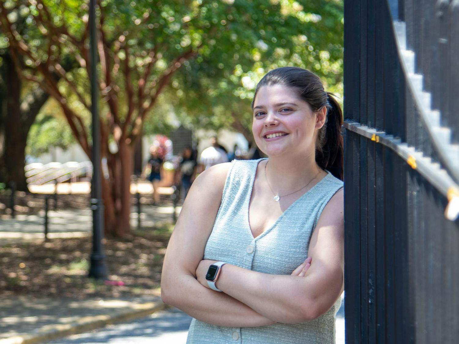 Kate Robins, editor-in-chief of The Daily Gamecock, poses for a photo in front of the gates on Greene Street on Aug. 19, 2024. Robins, a senior at the University of South Carolina, encourages people to take on new experiences and opportunities.