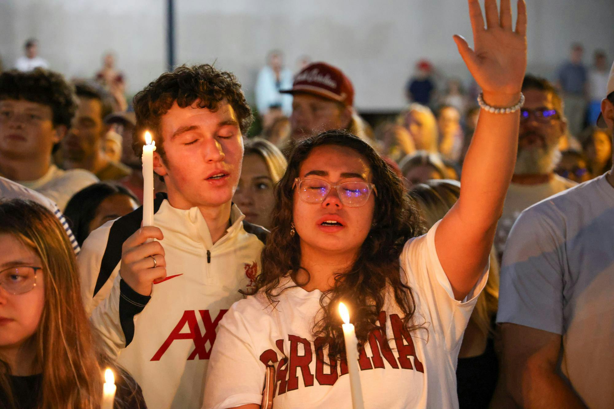 A couple embrace while holding candles at the vigil for Charlie Kirk on Sept. 15, 2025. Dozens of USC students and Columbia residents gathered on Greene Street to host an impromptu vigil for the slain founder of TPUSA.