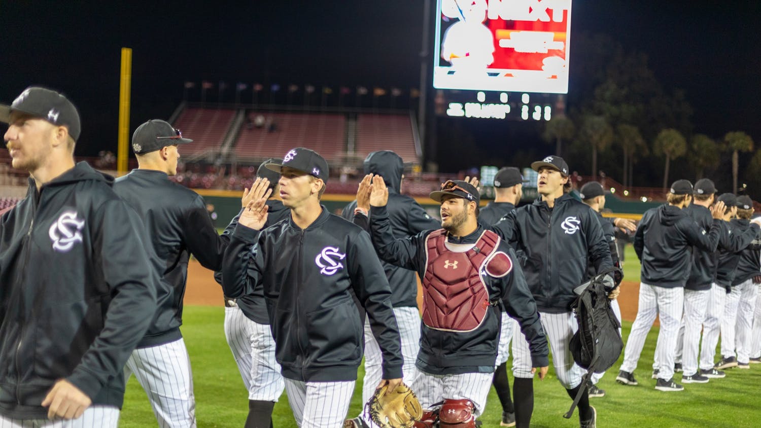 The South Carolina baseball team give high fives at the end of a game against Vanderbilt on Friday, March 25, 2022 in Columbia, SC.