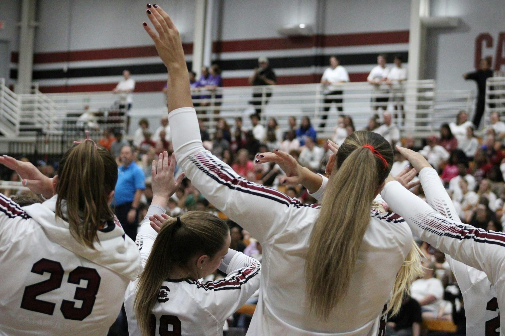 The Gamecocks volleyball team perform a dabbing motion on the sideline during the game against Texas A&amp;M on Oct. 1, 2025. The Gamecocks lost to the Aggies 3-1.