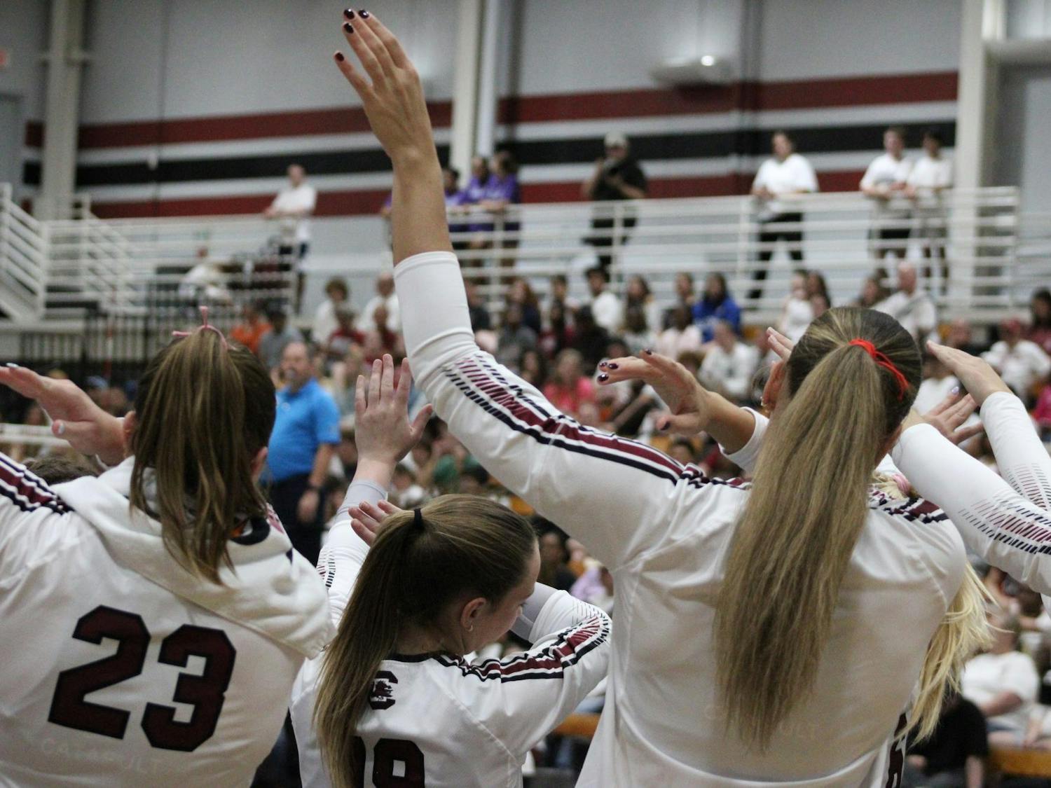 The Gamecocks volleyball team perform a dabbing motion on the sideline during the game against Texas A&M on Oct. 1, 2025. The Gamecocks lost to the Aggies 3-1.