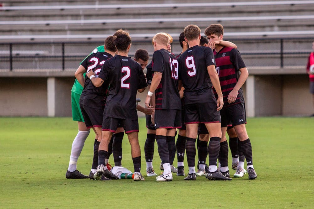 <p>FILE— The men’s soccer team gathers together in a huddle before their game against Gardner-Webb on Sept. 28, 2021.</p>