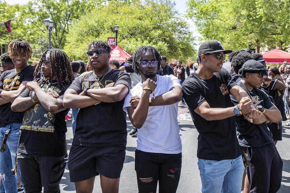 <p>Members of the Alpha Phi Alpha fraternity step to the music during their weekly Hip Hop Wednesday event on Greene Street. The event is hosted by the National Pan-Hellenic Council and allows members of the nine Black fraternities and sororities on campus to come together and share their culture.</p>