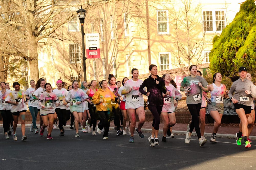 <p>Group of participants in Dance Marathon's annual 5K marathon jog down Greene Street on Saturday, Feb. 26, 2022. Participants of USC Dance Marathon's annual 5K race ran the race covered in colorful clothing too, as part of this edition's "color run."</p>
