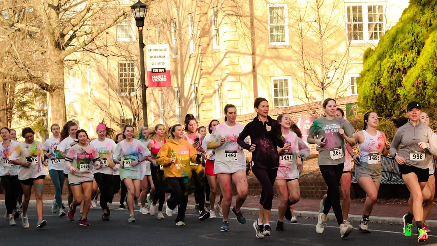 Group of participants in Dance Marathon's annual 5K marathon jog down Greene Street on Saturday, Feb. 26, 2022. Participants of USC Dance Marathon's annual 5K race ran the race covered in colorful clothing too, as part of this edition's "color run."