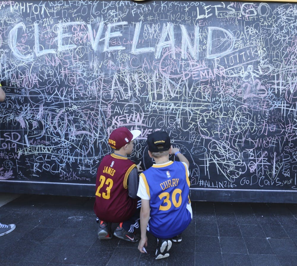 Young fans of LeBron James and Stephen Curry fan sign a chalk wall, sponsored by Rustoleum, outside Quicken Loans Arena before the Cleveland Cavaliers play host to the Golden State Warriors in Game 3 of the NBA Finals on Wednesday, June 8, 2016, in Cleveland. (Phil Masturzo/Akron Beacon Journal/TNS)