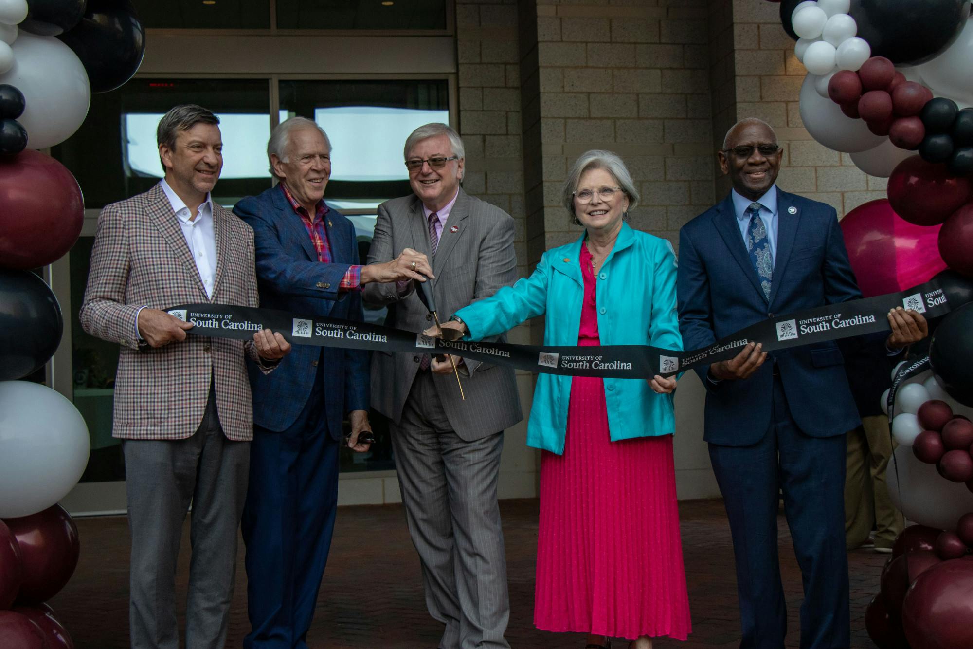 University of South Carolina President Michael Amiridis smiles for a picture during the Campus Village ribbon-cutting ceremony with Sen. Katrina Shealy. The construction on Campus Village first started in 2021.Editor's Note: This caption previously misidentified a person in the photo. The name has been corrected. 