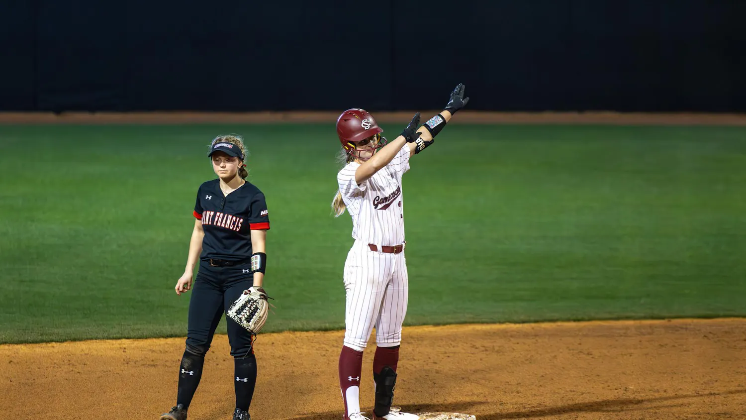 FILE – Senior infielder Ella Chancey celebrates on second base after hitting a double and batting in a run against St. Francis on Feb. 8, 2025. Chancey transferred from Charlotte this year, following the new head coach and numerous other players.