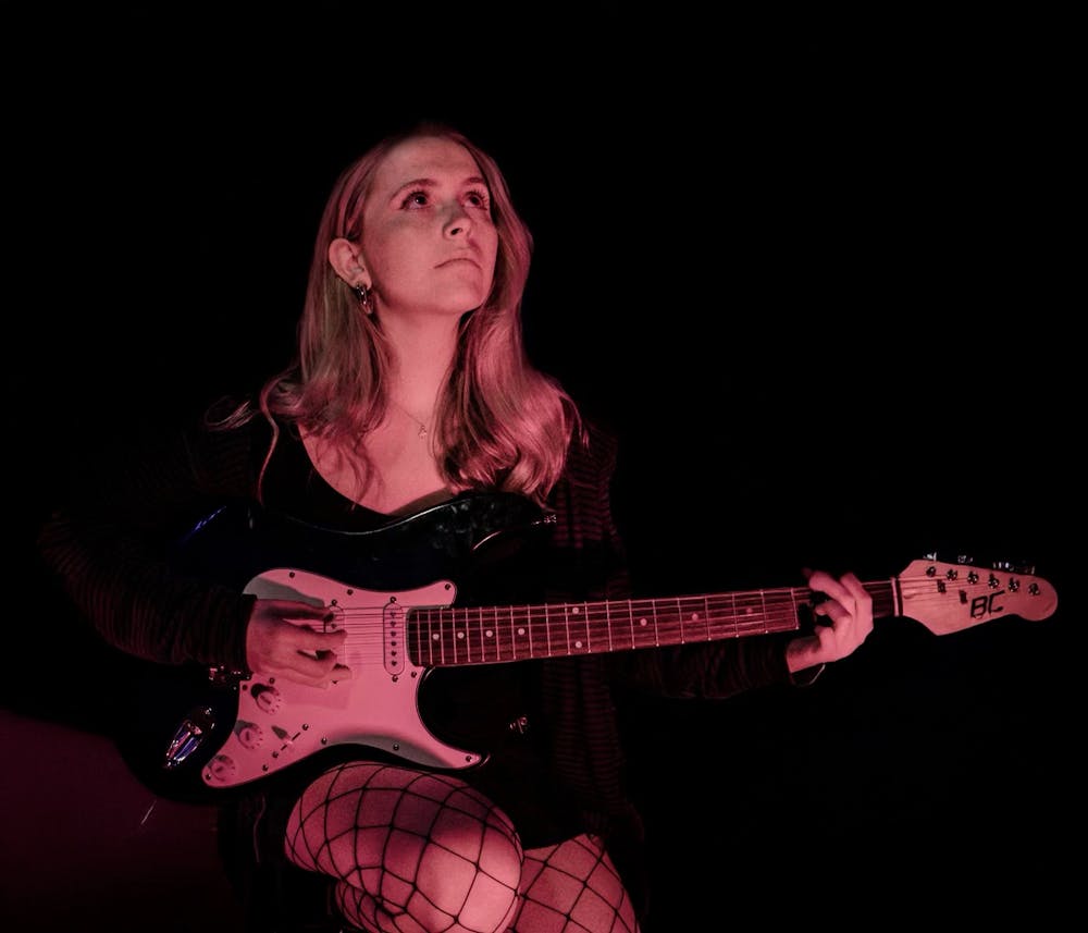 <p>Second-year music industry studies student Katie DeMartini plays guitar as she poses for a photoshoot for Blossom Magazine in late Feb. 2025. Originally from New Jersey, DeMartini has performed locally around Columbia in her years as a student at the University of South Carolina.</p>