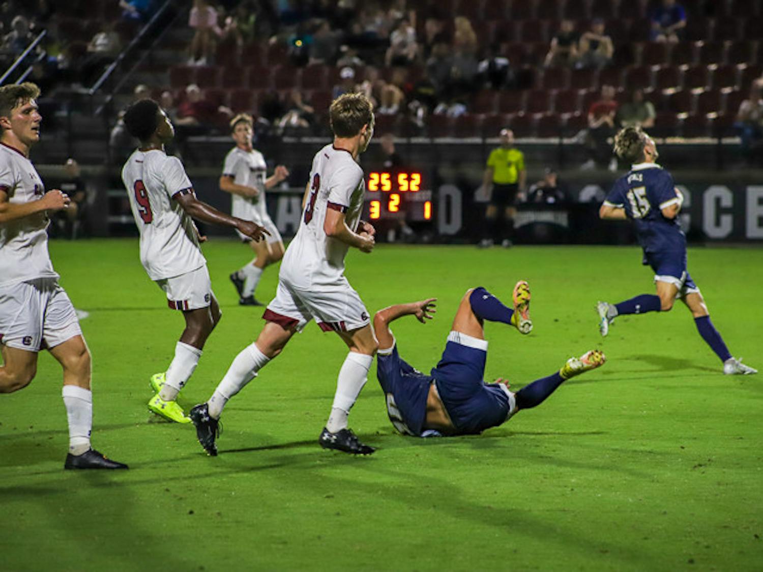 A Queens player falls during the matchup with South Carolina on Sept. 20, 2022. Queens received three yellow cards during the game and the Gamecocks received two.