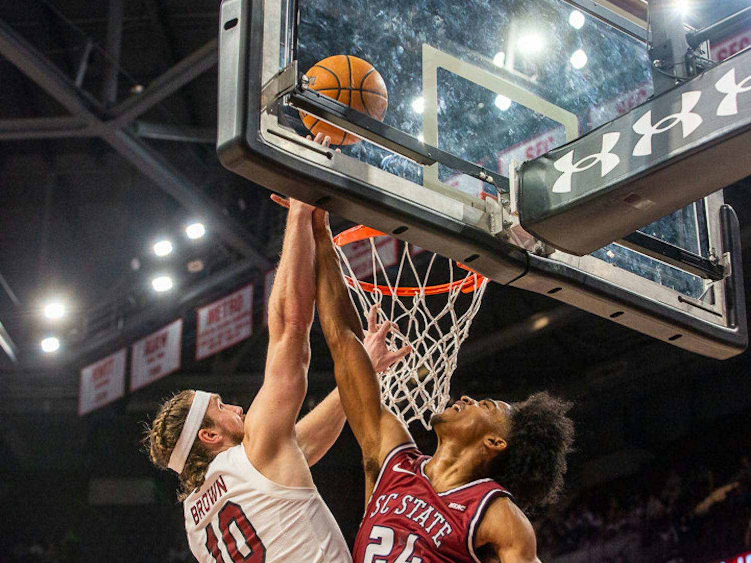 Graduate student forward Hayden Brown (on left) makes a challenge against S.C. State to get the lay-up for his team. This second-half score helped give the Gamecocks a close win over the Bulldog’s on Nov. 8, 2022.
