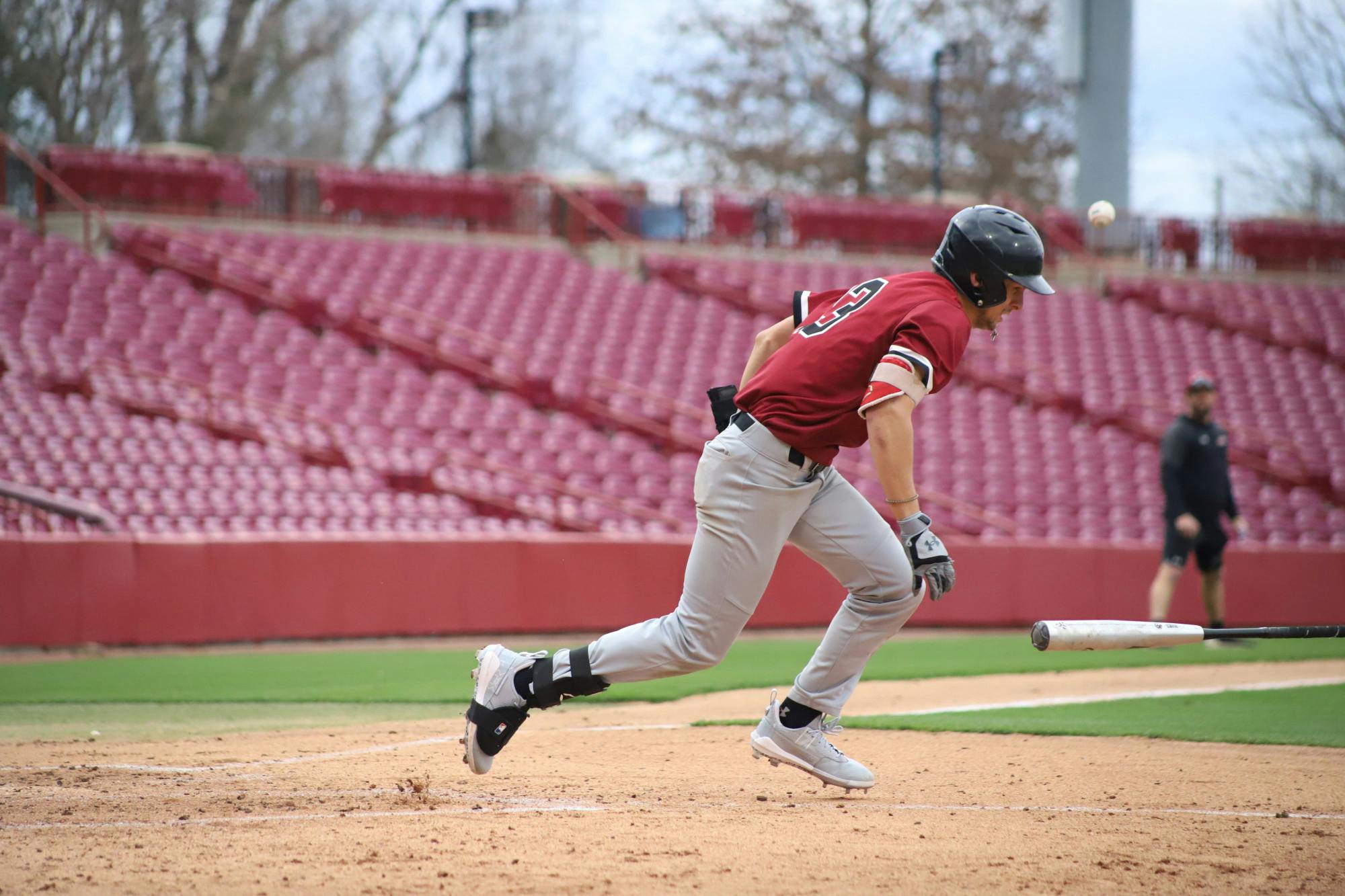 FILE—Sophomore catcher Cole Messina tossing his bat off to the side after getting walked by team Black. The Garnet and Black scrimmage was held on Feb. 1, 2023, at Founder's Park, where team Garnet beat team Black 4-2.