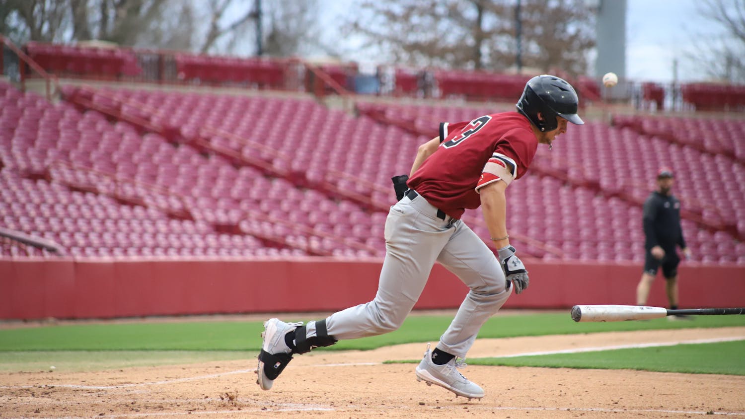 FILE—Sophomore catcher Cole Messina tossing his bat off to the side after getting walked by team Black. The Garnet and Black scrimmage was held on Feb. 1, 2023, at Founder's Park, where team Garnet beat team Black 4-2.