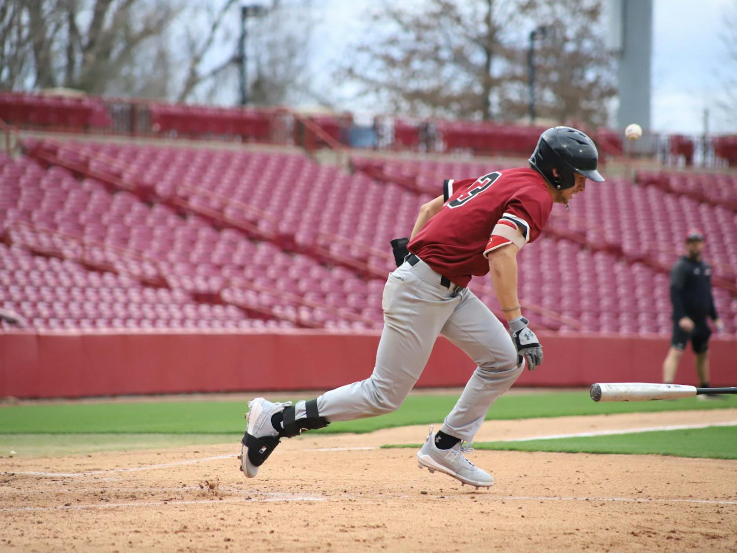 FILE—Sophomore catcher Cole Messina tossing his bat off to the side after getting walked by team Black. The Garnet and Black scrimmage was held on Feb. 1, 2023, at Founder's Park, where team Garnet beat team Black 4-2.