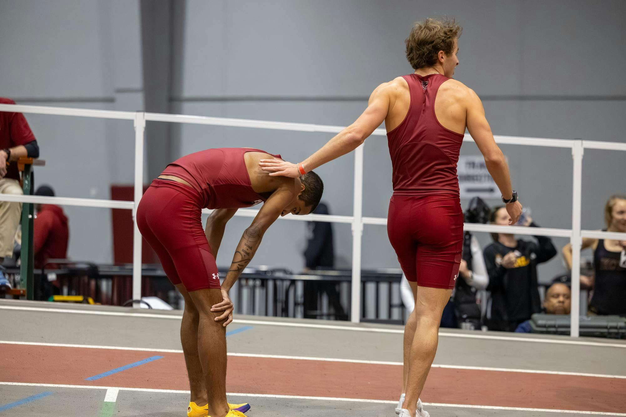 Sophomore distance runner Marcellus Mines rests while patted by sophomore distance runner Ricky Circelli at the Carolina Classic track and field meet on Feb. 7, 2026. Mines came in third, while Circelli did not finish.