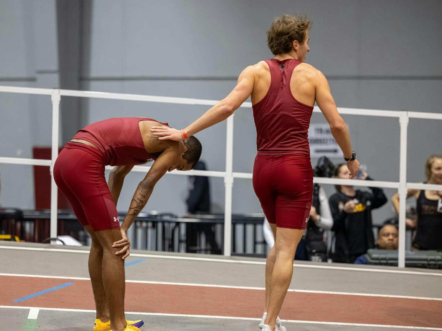 Sophomore distance runner Marcellus Mines rests while patted by sophomore distance runner Ricky Circelli at the Carolina Classic track and field meet on Feb. 7, 2026. Mines came in third, while Circelli did not finish.