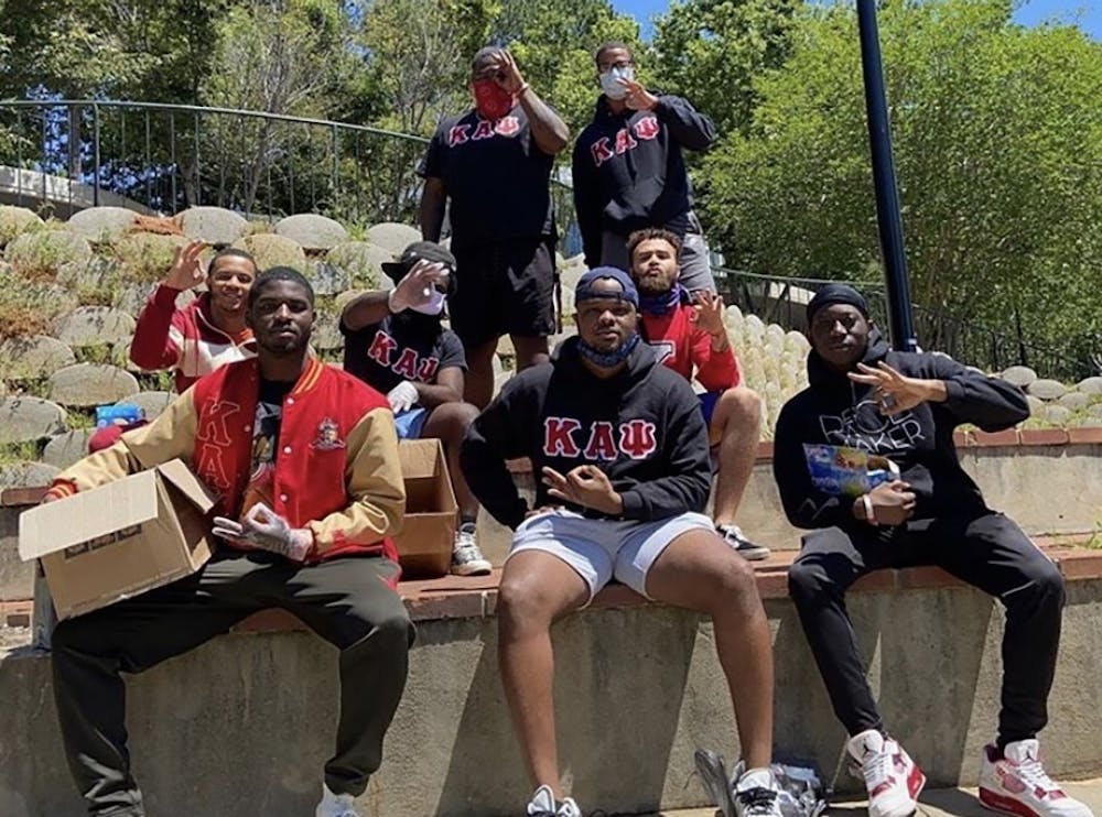 Brothers of the Zeta Epsilon chapter of Kappa Alpha Psi help feed the homeless at Finley Park.