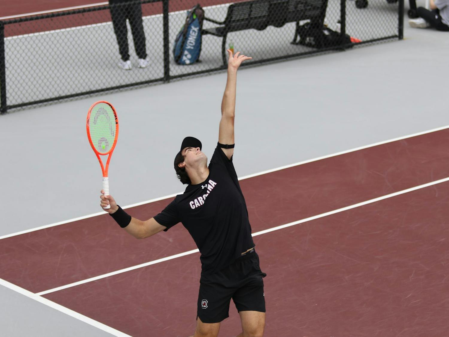 Senior Lucas Andrade da Silva serves during his doubles match with redshirt freshman Paul Barbier Gazeu against the University of Texas on Feb. 27, 2026. The pair won their match against the Longhorns 6-4.