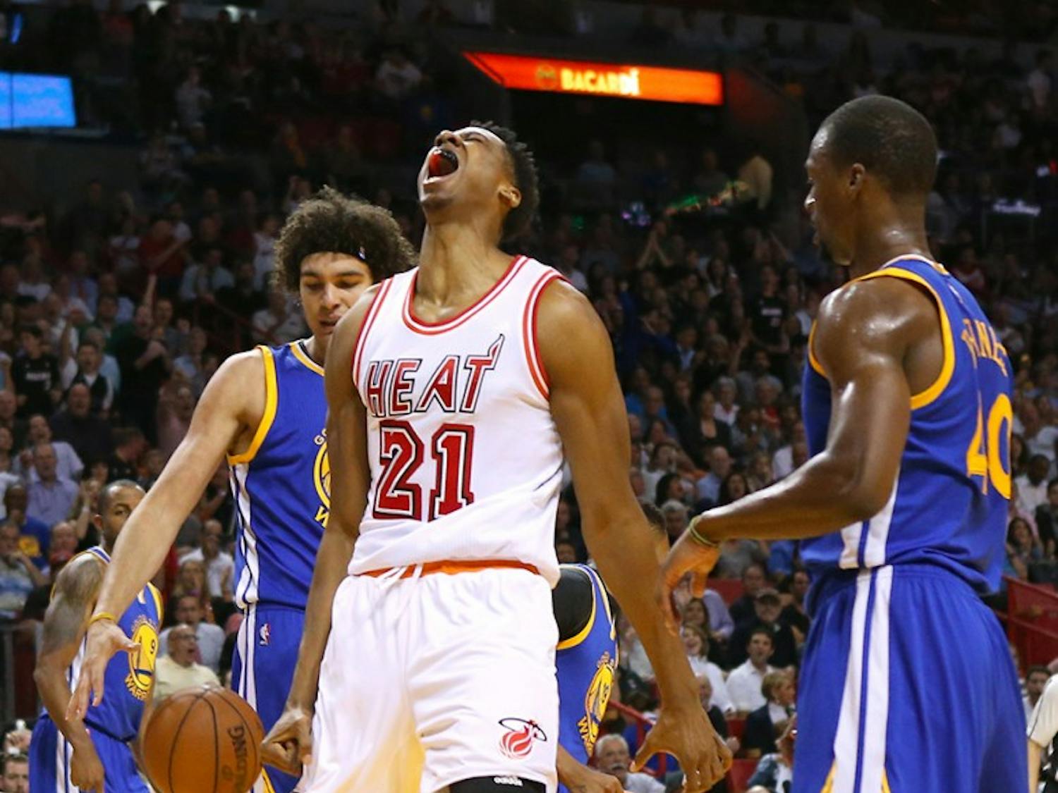 The Miami Heat's Hassan Whiteside, middle, reacts after dunking during the first quarter against the Golden State Warriors at the AmericanAirlines Arena in Miami on Wednesday, Feb. 24, 2016. (David Santiago/Miami Herald/TNS)
