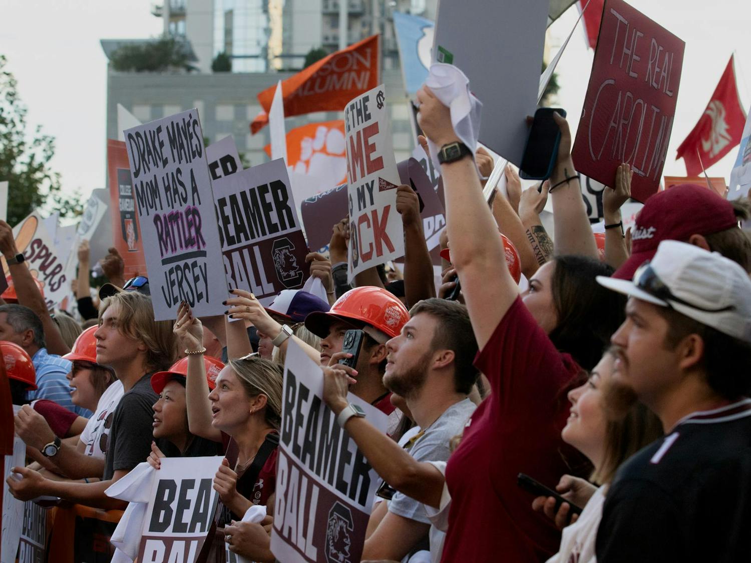 South Carolina fans in the front of the College GameDay pit raise signs for the ESPN broadcast. Fans at the front of the pit began lining up at 3 a.m. on Sept. 2, 2023.